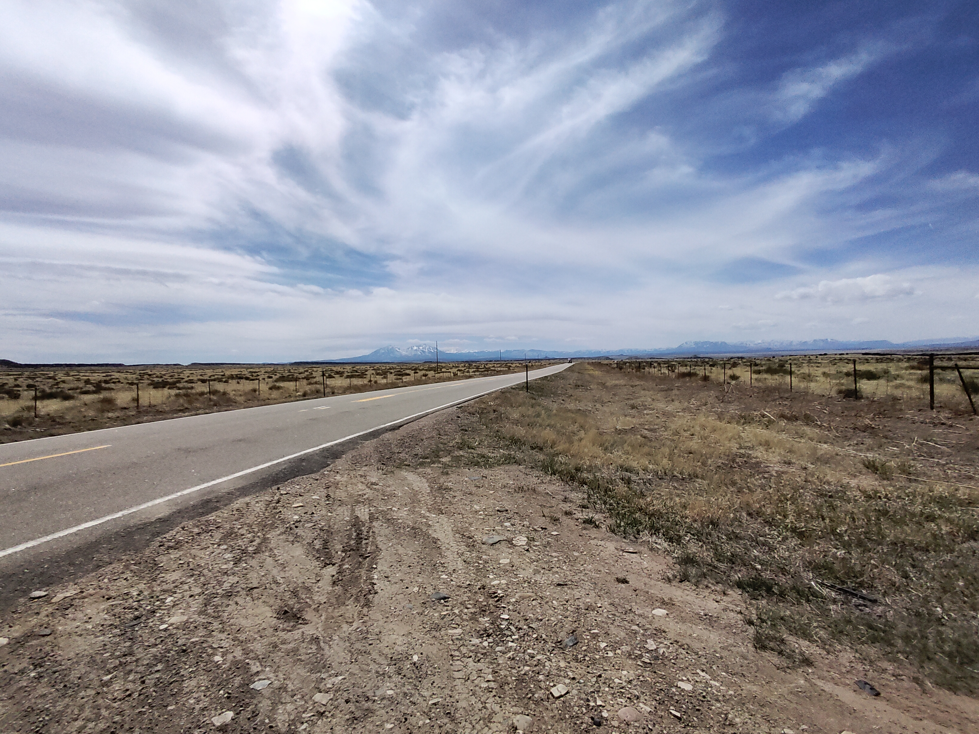 road out west with a blue sky